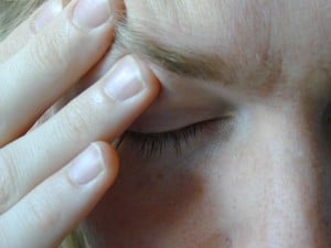 A close-up of a person's closed eye with their hand rubbing their temple in exasperation. Source: Living Life on Crutches