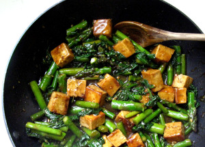 Stir fry with tofu and asparagus in a black pan.  Source: Live. Love. Learn. Eat.