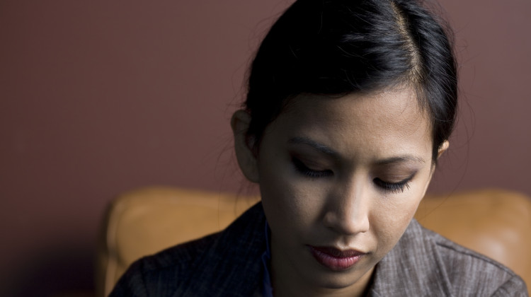 Queer woman of color looking despondent