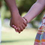 Two children holding hands