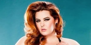 Plus-size model Tess Munster looks seductively at the camera against a teal background