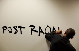 Person writing "Post-Racial" on a wall