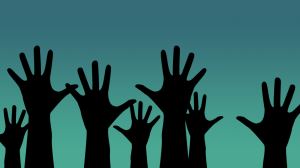 Silhouettes of raised hands against a gradient background of teal and sea green