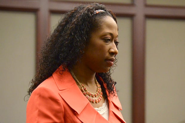 Marissa Alexander enters the courtroom during a hearing in the Duval County Courthouse in Jacksonville, Florida June 10, 2014. Alexander was initially convicted in 2012 and sentenced to 20 years in jail after firing what the mother of three described as a warning shot into the kitchen wall of her home in the direction of her estranged husband.  Her sentence was later overturned on appeal but prosecutors are seeking a retrial which now will be postponed until December 1, 2014.  REUTERS/Bob Mack/The Florida Times-Union/Pool  (UNITED STATES - Tags: CRIME LAW SOCIETY) - RTR3T3HM