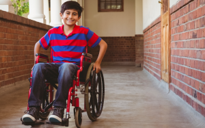 A child in a wheelchair is smiling
