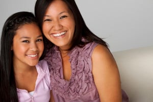 A parent and teenage child, smiling