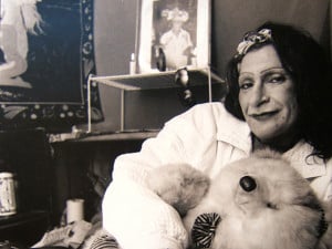 A black-and-white image of Sylvia Rivera, holding onto a teddy bear
