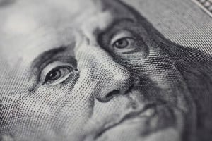 A close-up of Benjamin Franklin's face on a 100-dollar bill