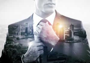 A business person putting on a tie, overlapping with a sprawling city