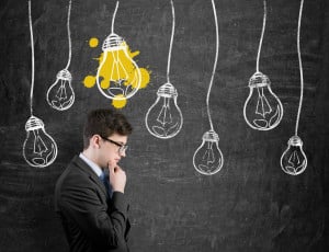 Businessperson thinking with lightbulb over head
