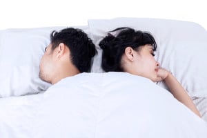 Two people, sleeping back-to-back