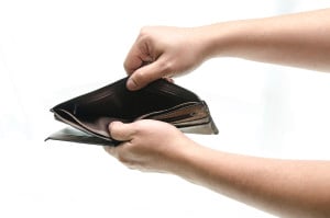 Empty wallet in male hands as symbol poverty and unemployment. Finance and poor economy. Isolated on white. Studio shot.