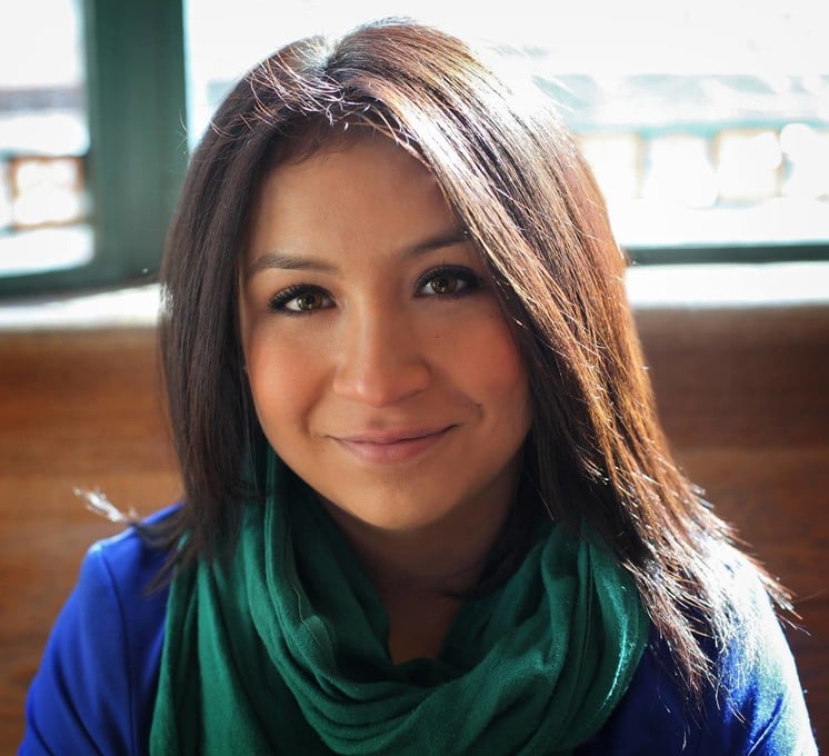 This photo features a Latina woman with shoulder-length, straight hair and a teal scarf smiling into the camera.