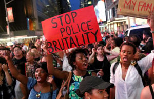 Activists protest in Times Square in response to the recent fatal shootings of two black men by police