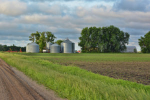 A farm site of grain storage bins and other farm equipment.
