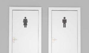 Two white restroom doors segregated by gender.
