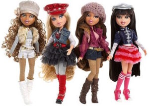 Four Bratz dolls with long hair, wearing glamorous outfits with high-heeled boots.
