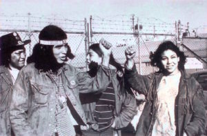Native activists at the 1969 Occupation of Alcatraz Island raise their fists. Image credit: “The Mouse That Roared.”