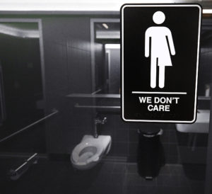 Black and white image of a gender neutral sign in a bathroom