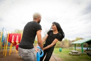 Two people being playful in a playground