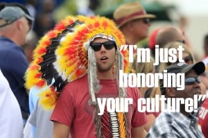 A person wearing a fake headdress with text reading "I'm just honoring your culture!"