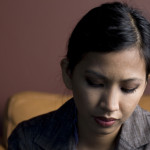 Queer woman of color looking despondent