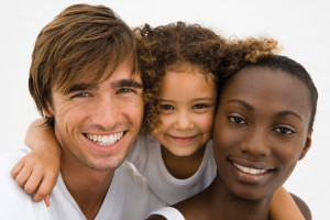 An interracial family smiles for the camera
