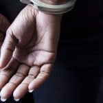 Handcuffed hands behind a woman's back