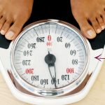 Arrow pointing to feet on a weighing scale, urging "STOP!"