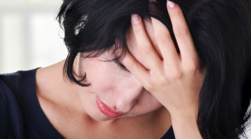 Person with their head in their hands