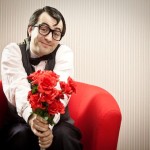 Person holding out a bouquet of roses