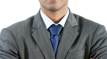 Person in a suit with their arms crossed