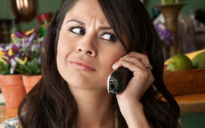 Person annoyed while talking on the phone, presumably at what the person on the other end is saying