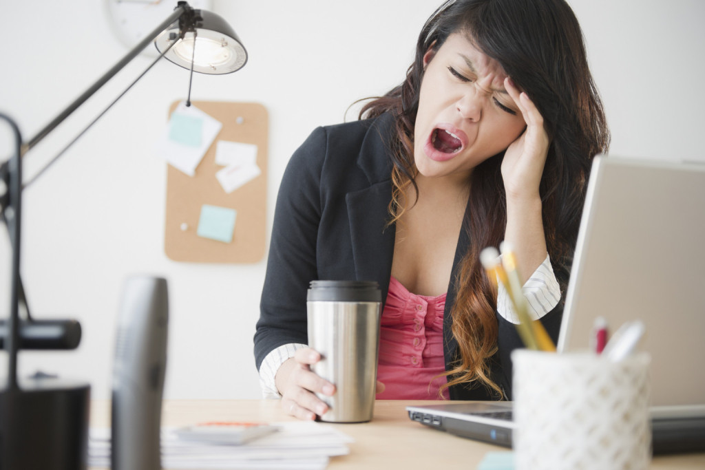 Person yawning at their desk