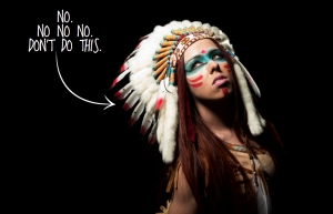 A person dressed up in a Native American costume. An arrow points to this person with the words "NO. NO NO NO. DON'T DO THIS" written in white.