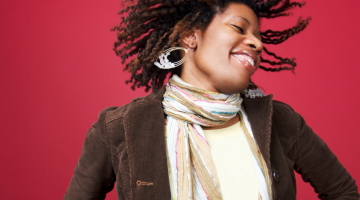A happy person is jumping in joy against a magenta background