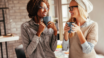 Two people smiling over coffee