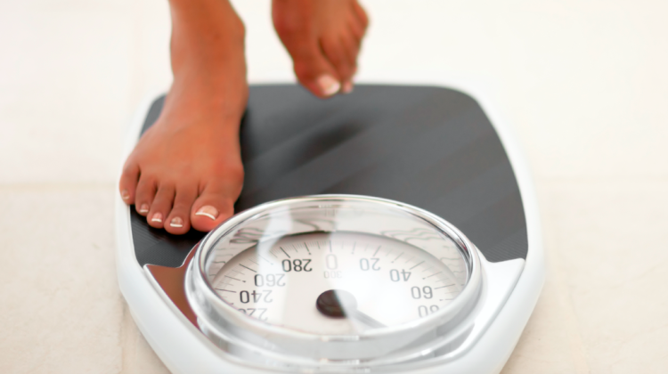A person stepping onto a bathroom scale
