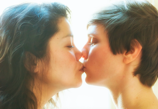 Two people kissing in the morning light