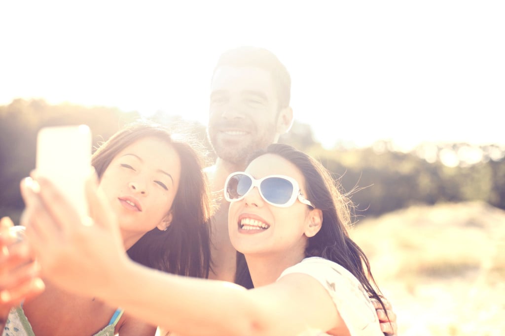 Three people taking a selfie together in the sun