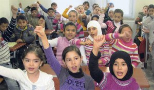 A group of students, cheering with their arms up