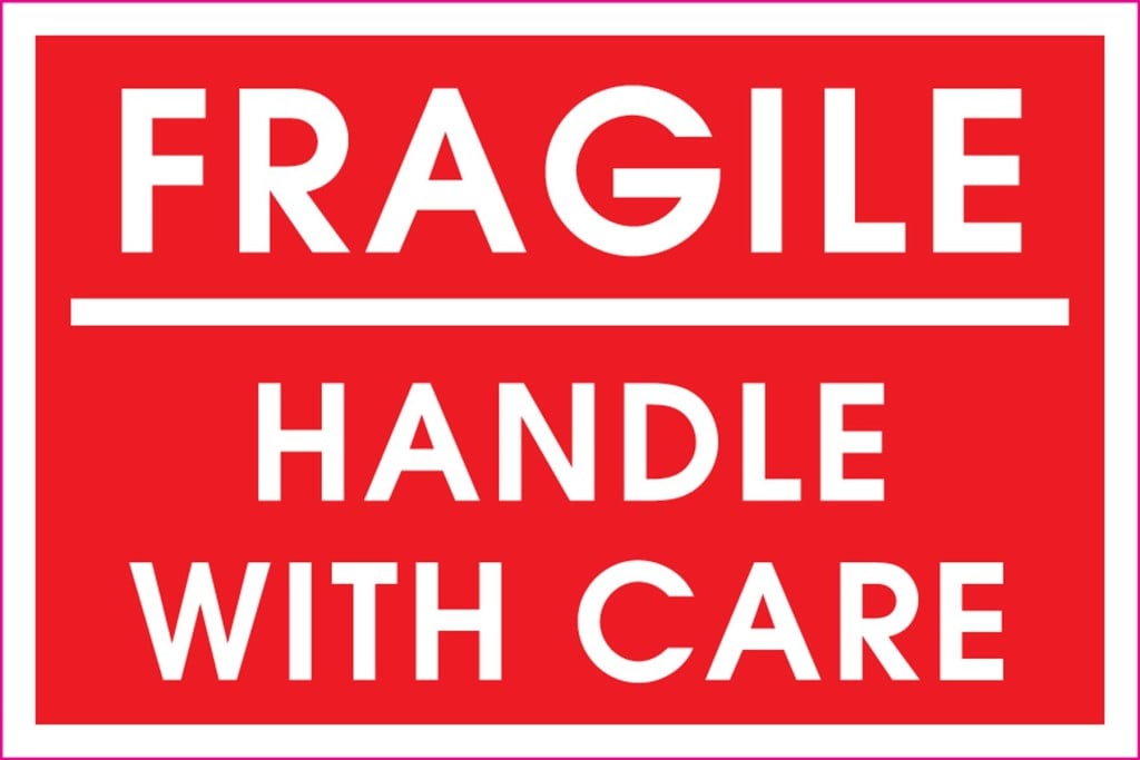 A red sign reads, in white, "Fragile: Handle with Care"