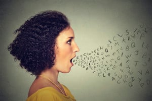 Person talking, with alphabet letters coming out of their mouth