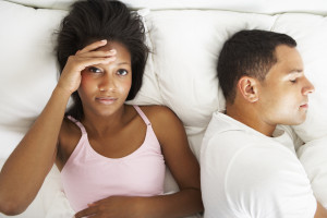 Couple in bed, experiencing sexual difficulties