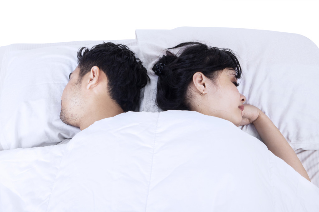 Two people, sleeping back-to-back