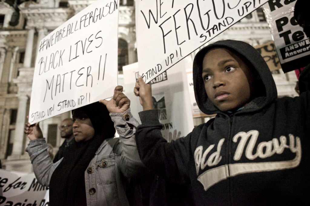 Philadelphia, PA USA - November 24, 2014; A young protester and his mother are seen holding signs at Dillworth Park at Philadelphia City Hall. (photo by Bas Slabbers)