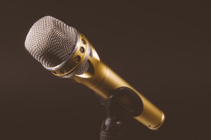 A golden microphone sits on a stand.