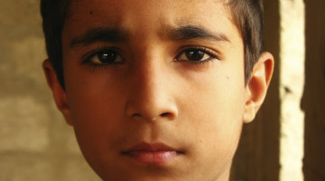 Close-up on a child who has a distressed facial expression.