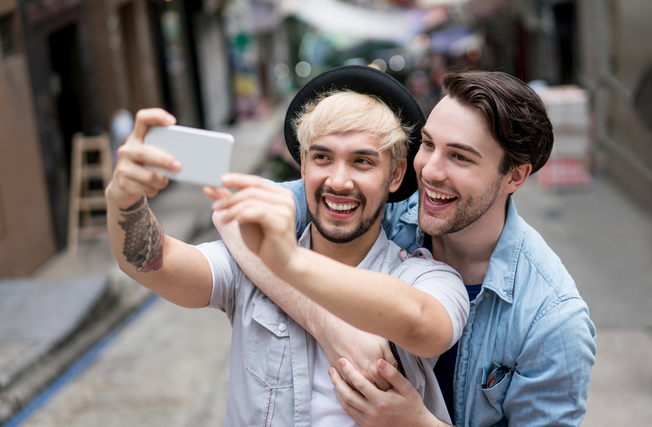Homosexual couple using smart phone generation y, young adult